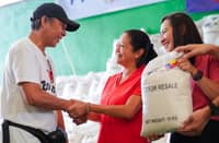 RICE, rights, raffles First Lady Liza Araneta-Marcos (center) personally leads the distribution of rice to residents at the Novaliches District Center in Jordan Plains Subdivision, Barangay Sta. Monica, Quezon City, on Friday. Beyond sacks of rice, beneficiaries also received raffle prizes — including rice cookers, television sets and additional rice.