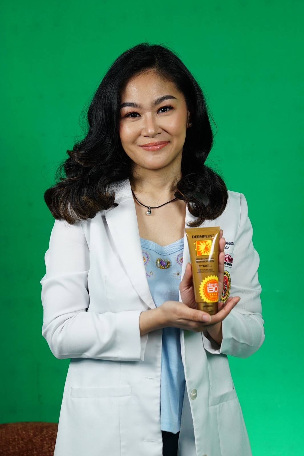 DOCTOR Angela Pineda holding the SPF 130 version of Dermplus Sunscreen
