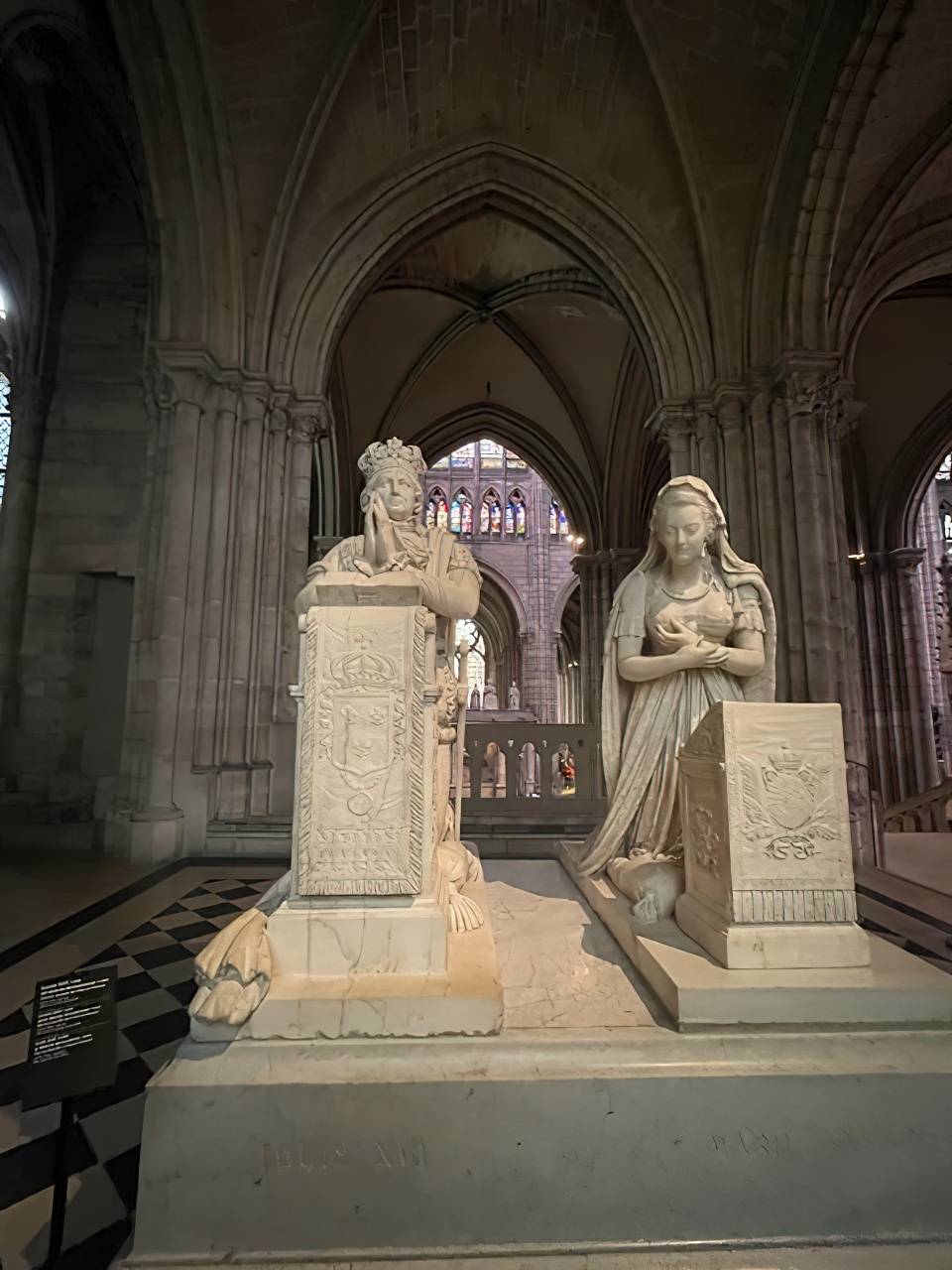 WHITE marble statues represent the funerary monument of King Louis XVI and Queen Marie-Antoinette.