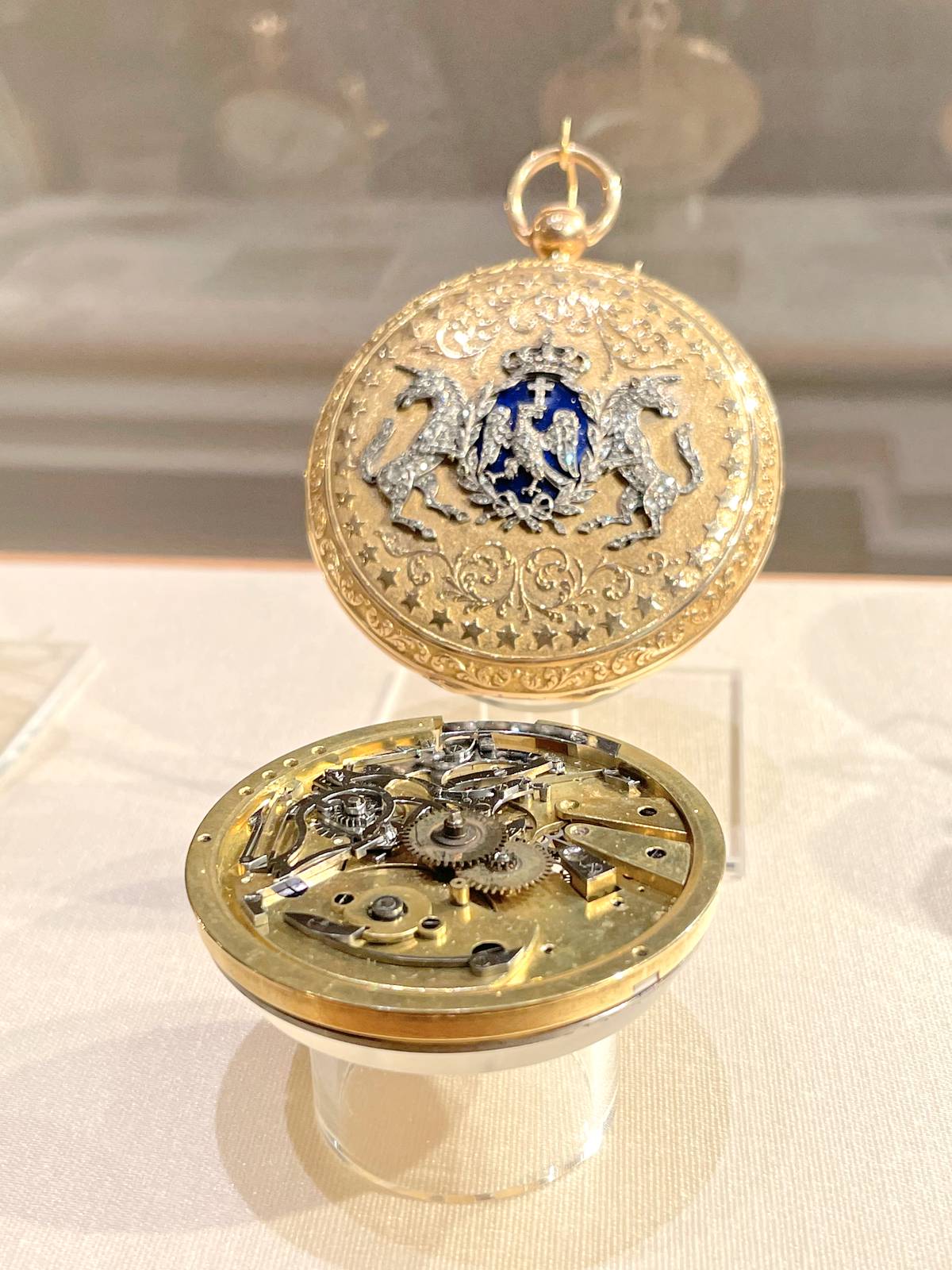 ANTQUE gold pocket watch from the Patek Philippe Museum features a blue enamel crest depicting two unicorns.