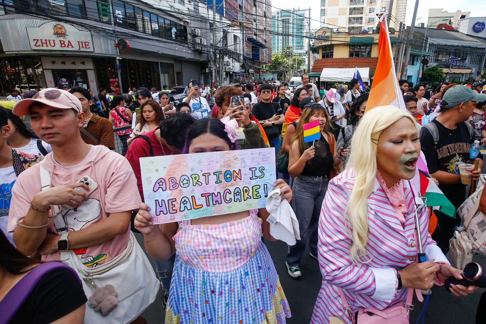 Members of the LGBTQIA+ community and their allies gather at Remedios Circle in Manila on 27 June 2026 during the Metro Pride March and Festival, calling for equality, dignity, justice, and human rights.
