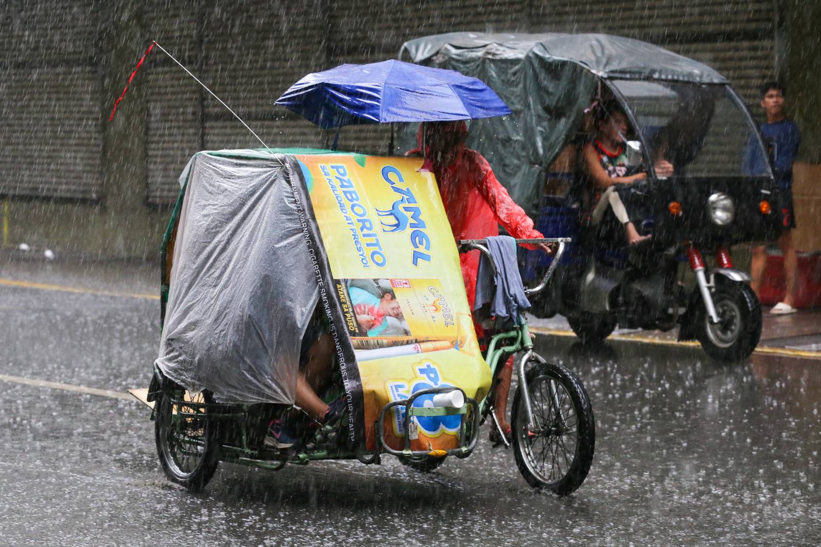 Umbrellas and raincoats are out along Soler Street in Manila on 27 June 2026 as the southwest monsoon, or "Habagat," and the Intertropical Convergence Zone (ITCZ) bring rains across several parts of the country. According to PAGASA, Habagat is expected to bring cloudy skies with scattered rain showers and thunderstorms over Metro Manila.