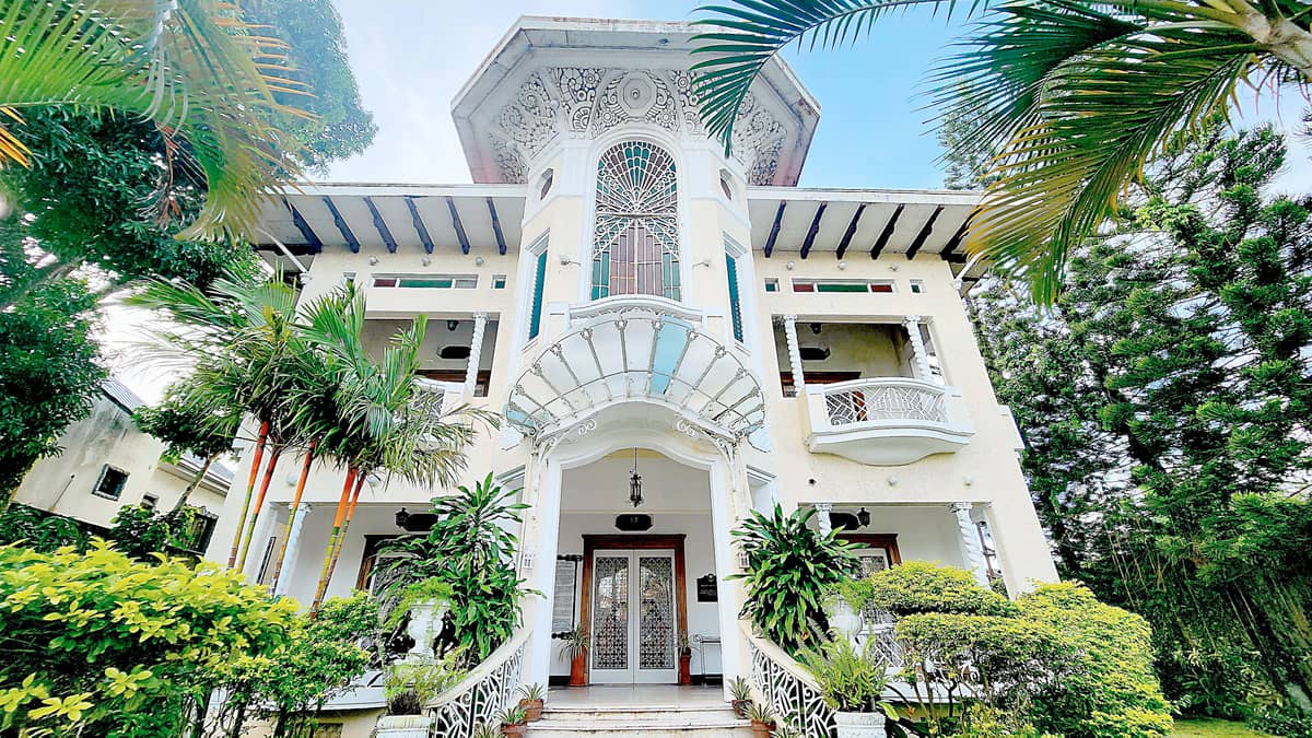GALA-RODRIGUEZ HOUSE, Sariaya, Quezon. Completed and inaugurated on 4 May 1935, the house was built by Dr. Isidro Rodriguez as a ‘dream home’ for his wife, Doña Gregoria Gala. Designed by National Artist Juan Nakpil, it features a mirador with decorative reliefs and stained-glass windows, and a fan-shaped glass canopy at the front entrance, said to be inspired by the Paris Métro entrances. Having survived World War II bombings and fires, it has become a tourist attraction and was designated as a heritage house in 2008 by the then National Historical Institute.