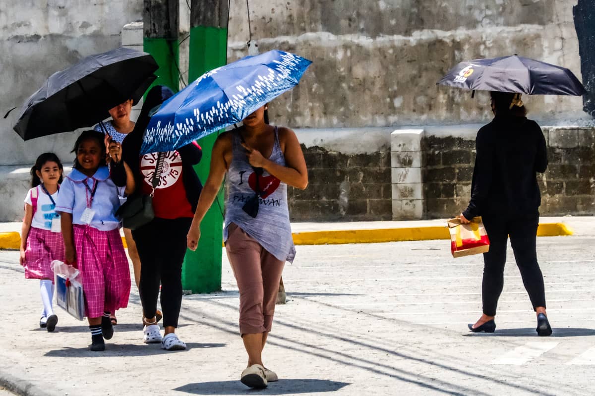 RAIN or shine, kids make the daily trek to school along Quirino Highway in Quezon City.