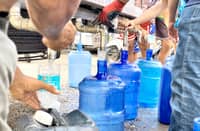 RESIDENTS of Glan fill containers with water from a tanker of Cebu Manila Water development.