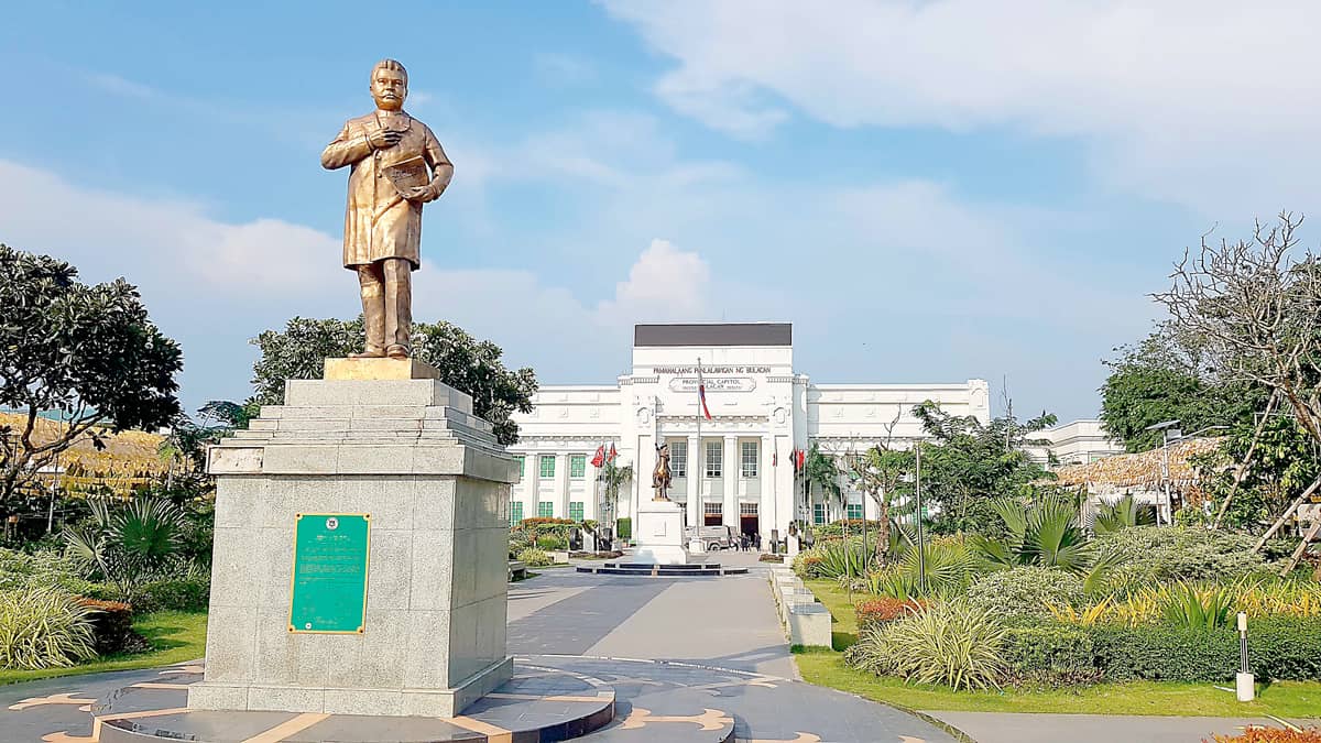 BULACAN PROVINCIAL CAPITOL BUILDING, Malolos, Bulacan. Designed by Juan Arellano and completed in 1930, it displays a stylistic transition from Neoclassicism to Art Deco. Its architecture retains the classical symmetry but simplifies ornamentation into geometric and cubist forms. It is accentuated by octagonal columns with plain capitals, tray panels on the frieze, wrought iron grills with rising sun design, and reliefs. The building was destroyed during the Second World War and was rebuilt in 1950, remaining an example of Arellano’s fusion of classical balance and emerging modernist sensibility.