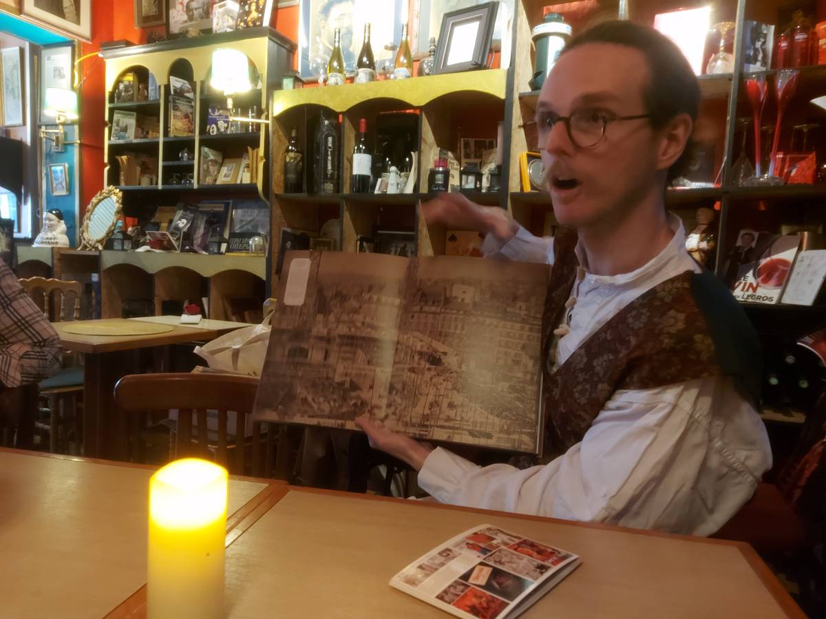 ANTIQUE book open to a detailed engraving of a city.