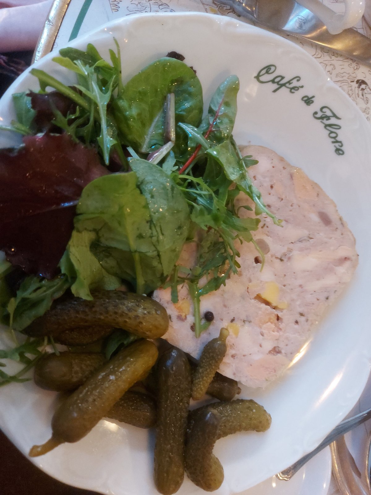 SLICE of pâté or terrine alongside pickled cornichons.