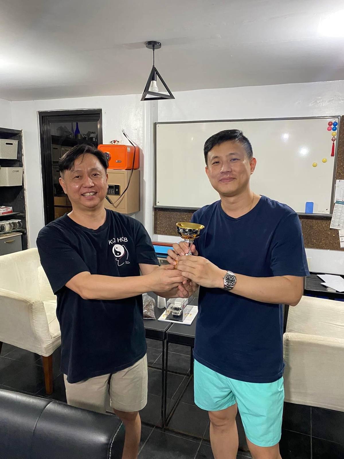 FOR the win: Brian Dy (right) gets the trophy.