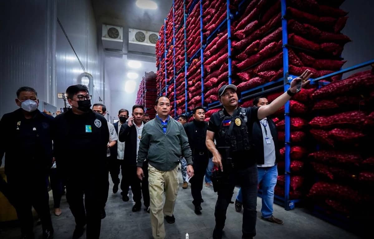 CUSTOM Commissioner Ariel Nepomuceno (center) arrives at a warehouse in Manila, where piles of smuggled agricultural products were seized in a recent raid.