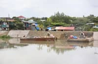 WORKERS hired by contractors of the Department of Public Works and Highways Bulacan 1st District Engineering Office carry out concrete laying for a riverbank protection structure along a waterway in Barangay Santa Cruz, Guiguinto, Bulacan, on Friday, 19 September 2025.