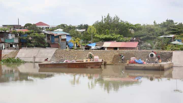 WORKERS hired by contractors of the Department of Public Works and Highways Bulacan 1st District Engineering Office carry out concrete laying for a riverbank protection structure along a waterway in Barangay Santa Cruz, Guiguinto, Bulacan, on Friday, 19 September 2025.