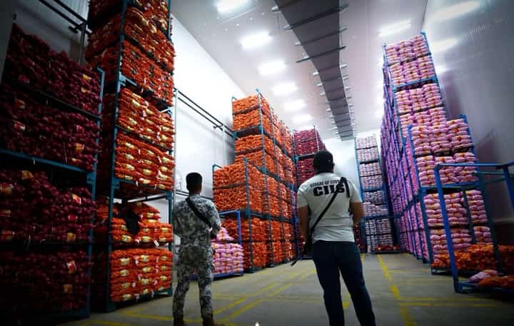 PERSONNEL of Bureau of Customs and Philippine Coast Guard check the smuggled items after a recent Manila raid.