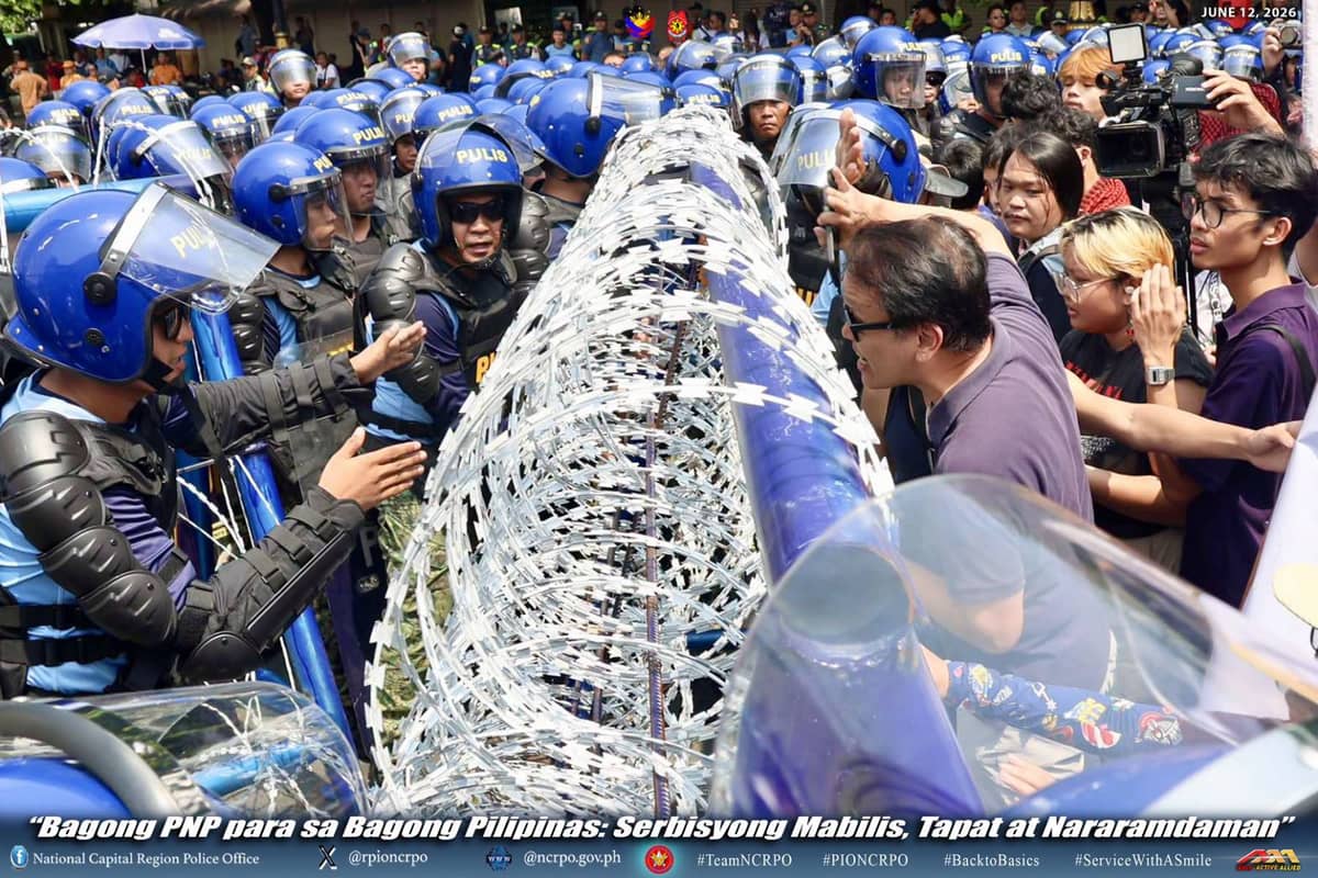POLICE officers from the NCRPO stand their ground against protesters at Mendiola, Kalaw Avenue, and the Senate vicinity, to ensure peaceful and secure commemorative operations.