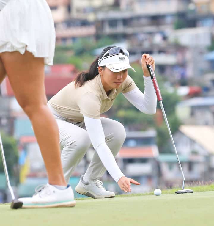 TIFFANY Lee lines her putt on the fourth green.