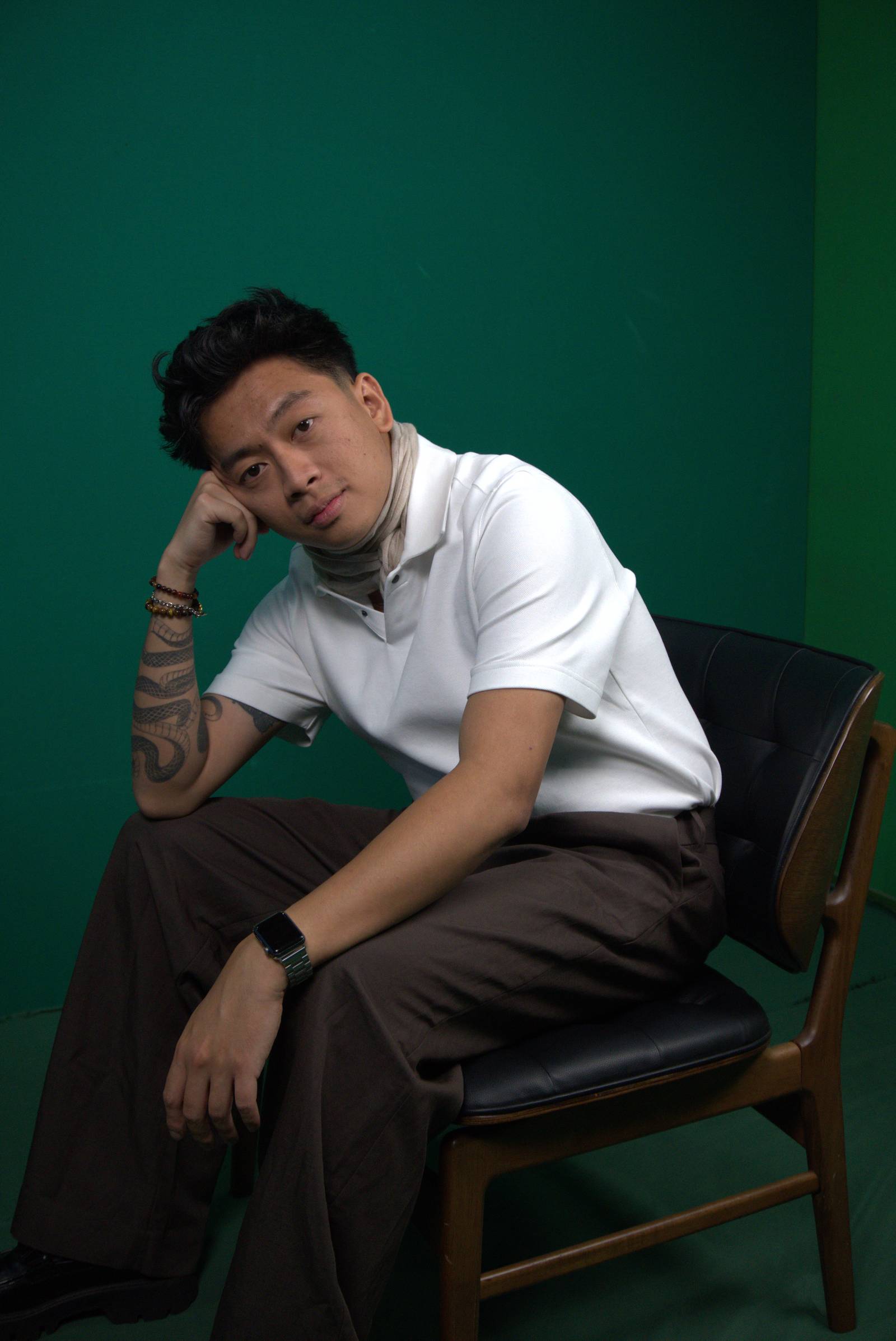 ALVIN Kasiban presents casual dressing in a white polo shirt, with a gently tucked scarf.