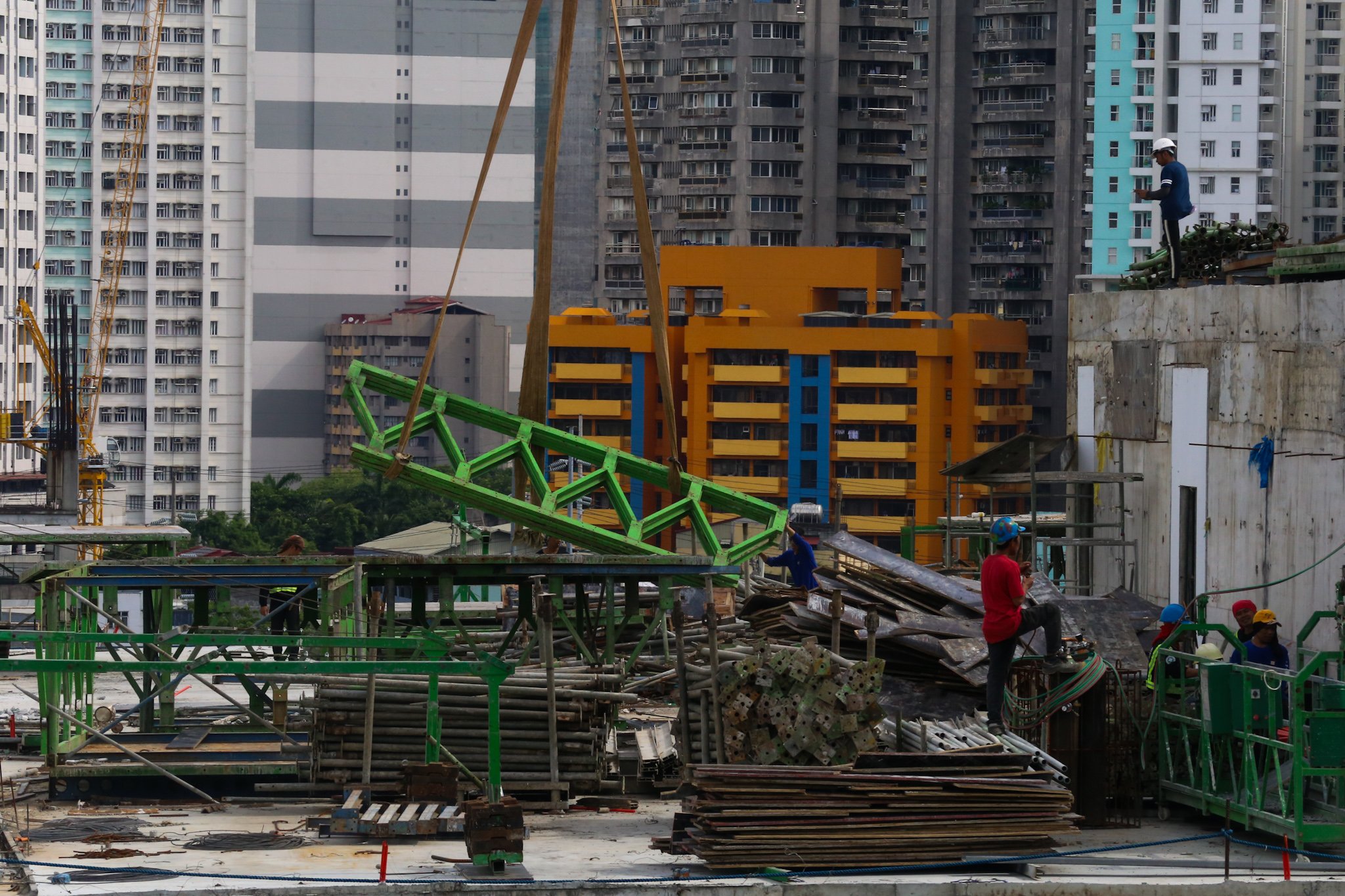 Workers prepare at a high-rise construction site along San Marcelino Street in Manila on 02 July 2026. The Department of Labor and Employment recently announced an ₱85 increase in the daily minimum wage for workers in the National Capital Region, to be implemented in two tranches beginning 19 July 2026.