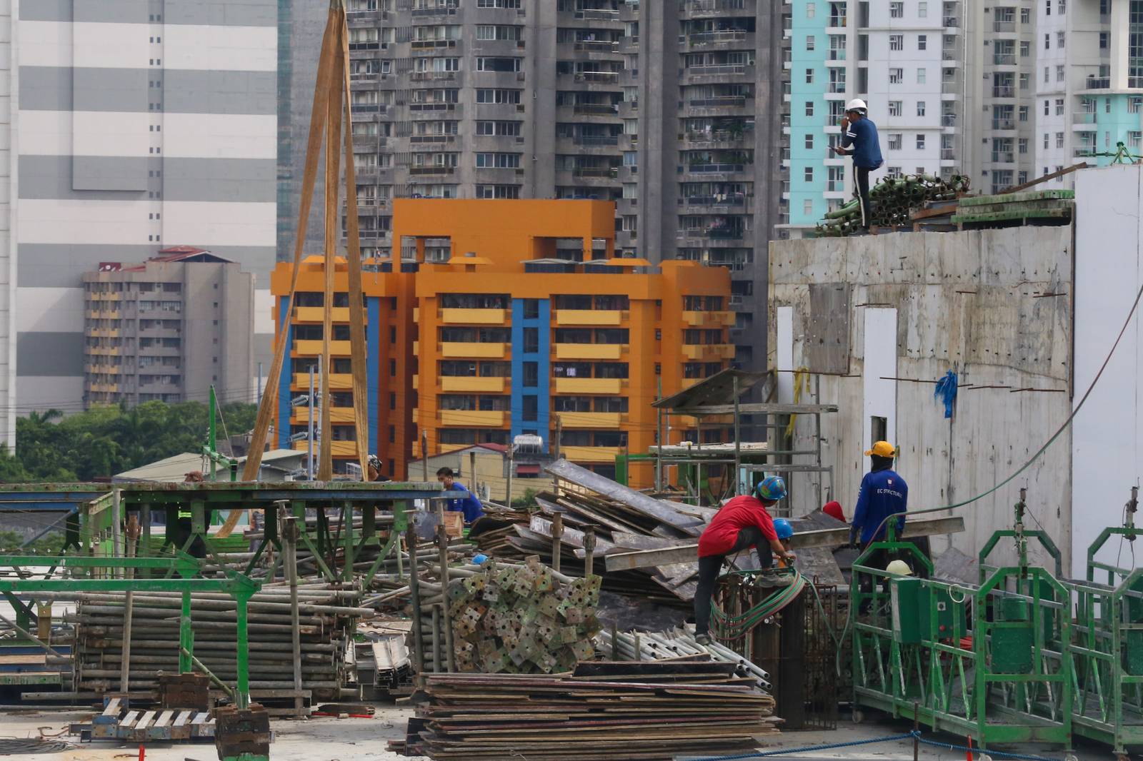 Workers prepare at a high-rise construction site along San Marcelino Street in Manila on 02 July 2026. The Department of Labor and Employment recently announced an ₱85 increase in the daily minimum wage for workers in the National Capital Region, to be implemented in two tranches beginning 19 July 2026.