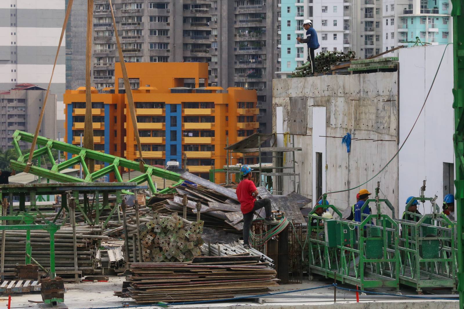 Workers prepare at a high-rise construction site along San Marcelino Street in Manila on 02 July 2026. The Department of Labor and Employment recently announced an ₱85 increase in the daily minimum wage for workers in the National Capital Region, to be implemented in two tranches beginning 19 July 2026.