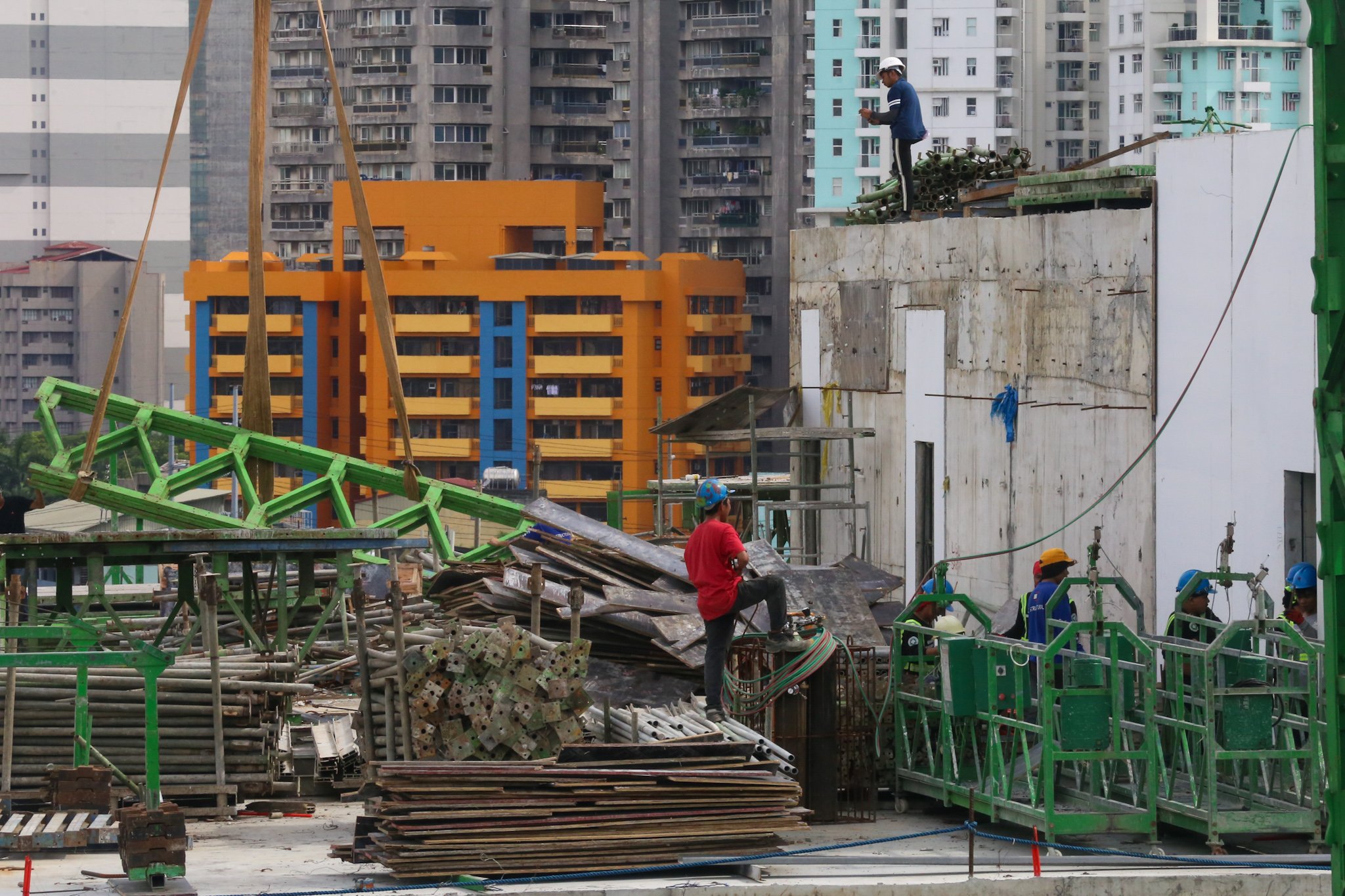 Workers prepare at a high-rise construction site along San Marcelino Street in Manila on 02 July 2026. The Department of Labor and Employment recently announced an ₱85 increase in the daily minimum wage for workers in the National Capital Region, to be implemented in two tranches beginning 19 July 2026.