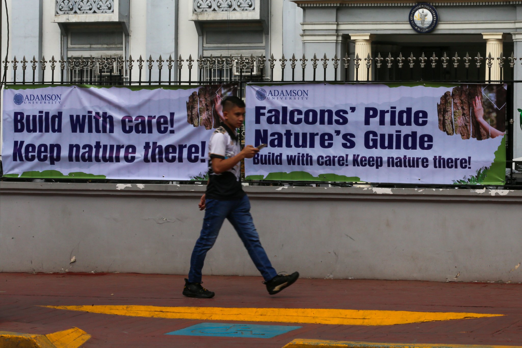 The Adamson University community displays green ribbons on its fences to call for the protection of green spaces and heritage sites and to protest the proposed construction of the Southern Access Link Expressway (SALEX). The community raises concerns over the project's possible impact on the university's campus environment, trees, surrounding community, and historical structures. The university has been designated a historical site by the National Historical Institute.