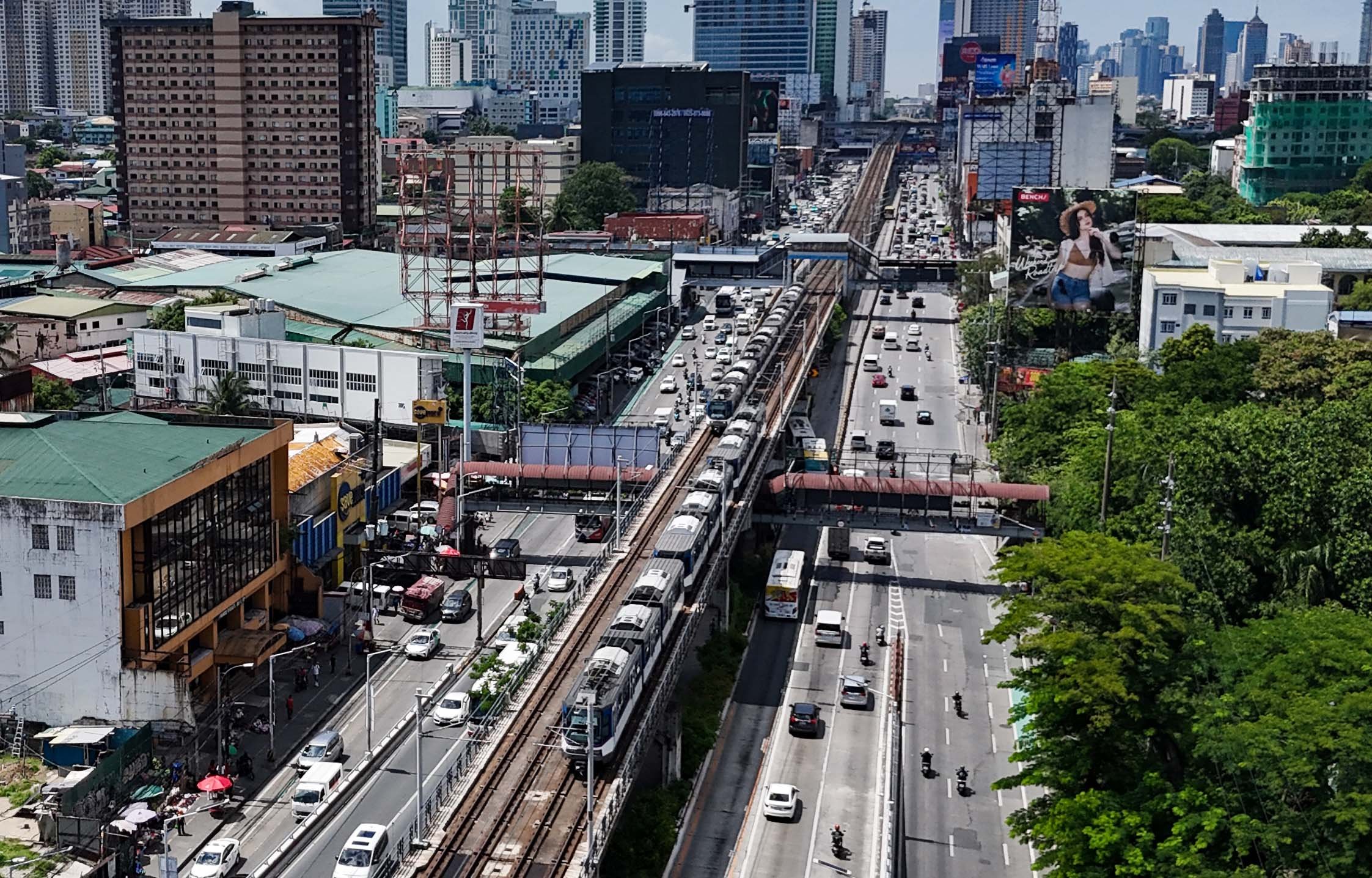 An MRT-3 train passes through Quezon City on 4 July 2026. The Department of Transportation said 26 Japanese companies have expressed interest in the government's plan to bid out the rail line's operations, maintenance and expansion under a public-private partnership scheme.

📸: Analy Labor