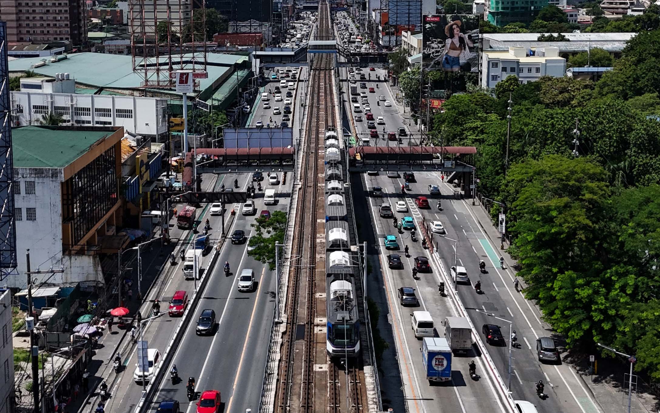 An MRT-3 train passes through Quezon City on 4 July 2026. The Department of Transportation said 26 Japanese companies have expressed interest in the government's plan to bid out the rail line's operations, maintenance and expansion under a public-private partnership scheme.

📸: Analy Labor