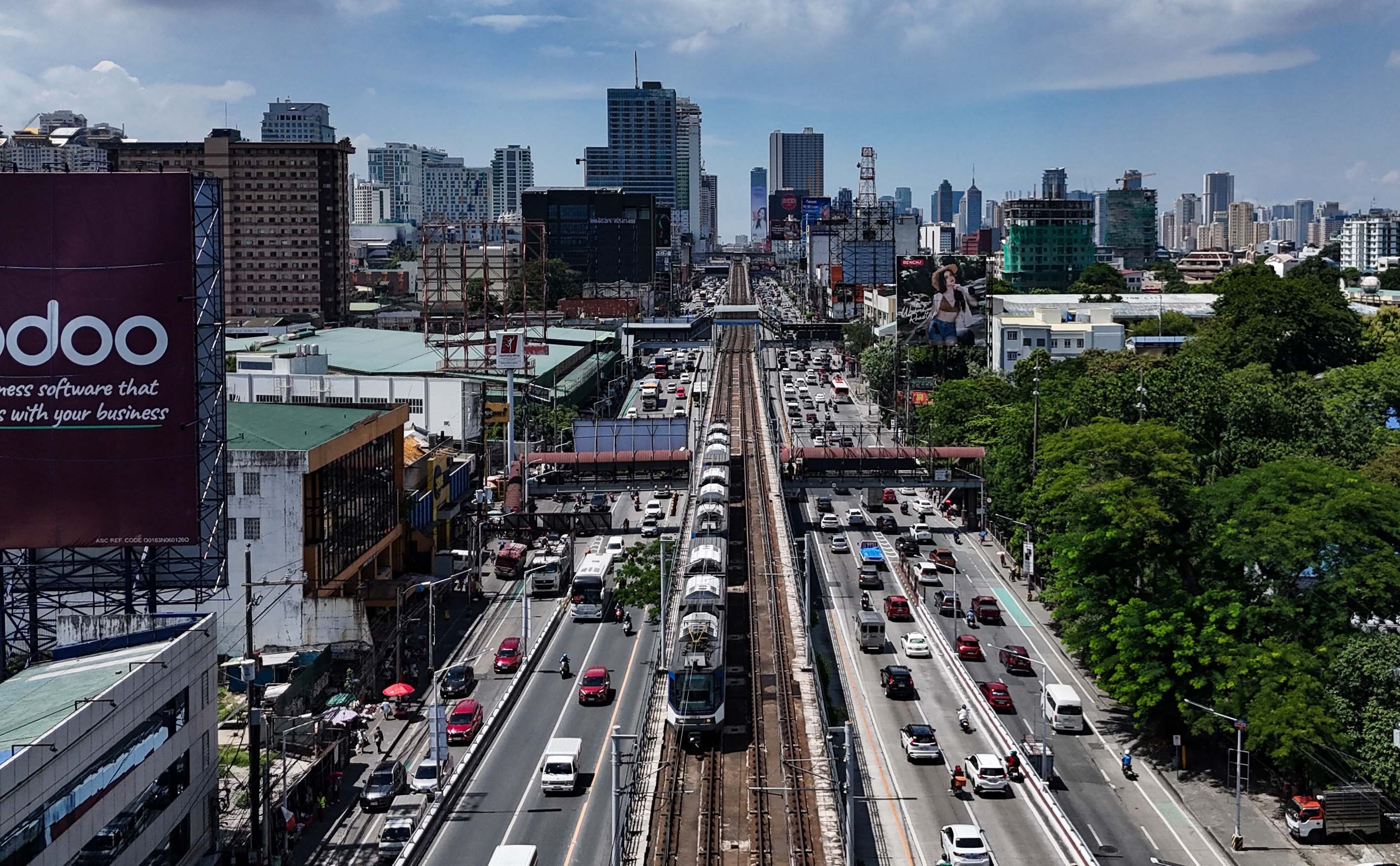 An MRT-3 train passes through Quezon City on 4 July 2026. The Department of Transportation said 26 Japanese companies have expressed interest in the government's plan to bid out the rail line's operations, maintenance and expansion under a public-private partnership scheme.

📸: Analy Labor