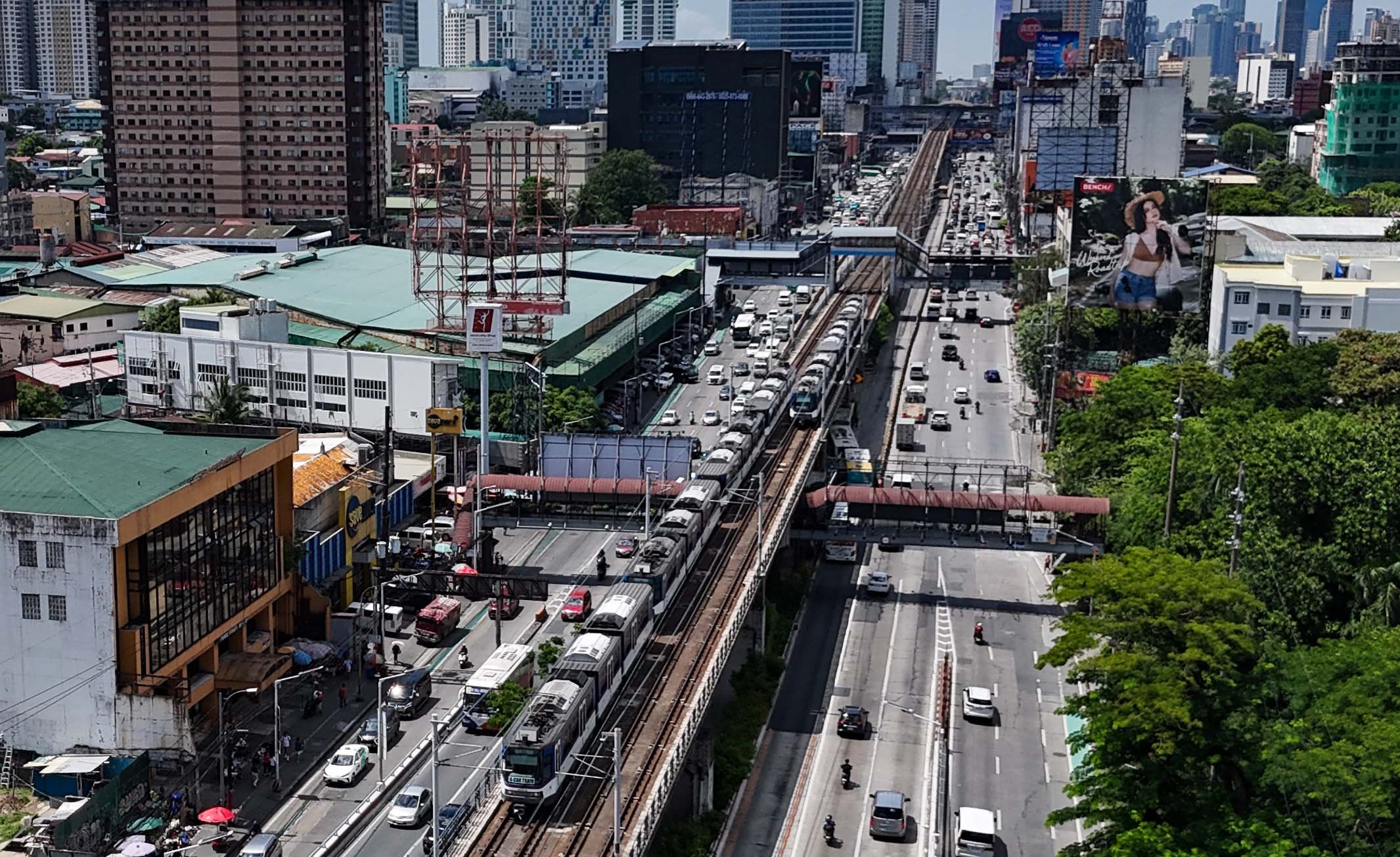 An MRT-3 train passes through Quezon City on 4 July 2026. The Department of Transportation said 26 Japanese companies have expressed interest in the government's plan to bid out the rail line's operations, maintenance and expansion under a public-private partnership scheme.

📸: Analy Labor