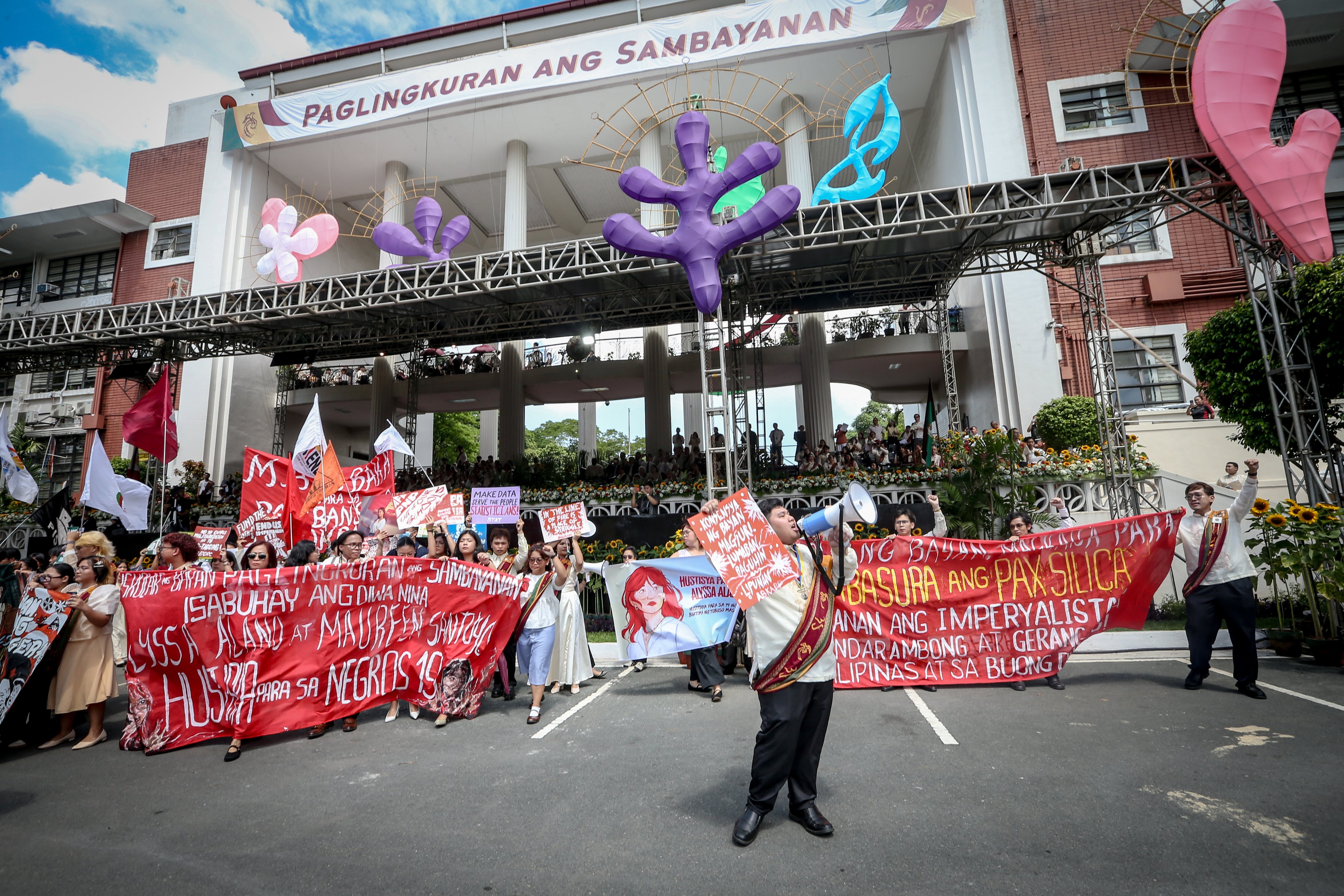 Various progressive graduates staged a protest after the graduation rites ceremony at University of the Philippines Diliman, Quezon City on Sunday, 5 July, 2026. 

Over 5022 students from various degrees celebrated their graduation rites.

Graduates were also seen to strike a pose at the University Avenue of UP Diliman on Sunday, 5 July, 2026 in Quezon City. | Aram Lascano