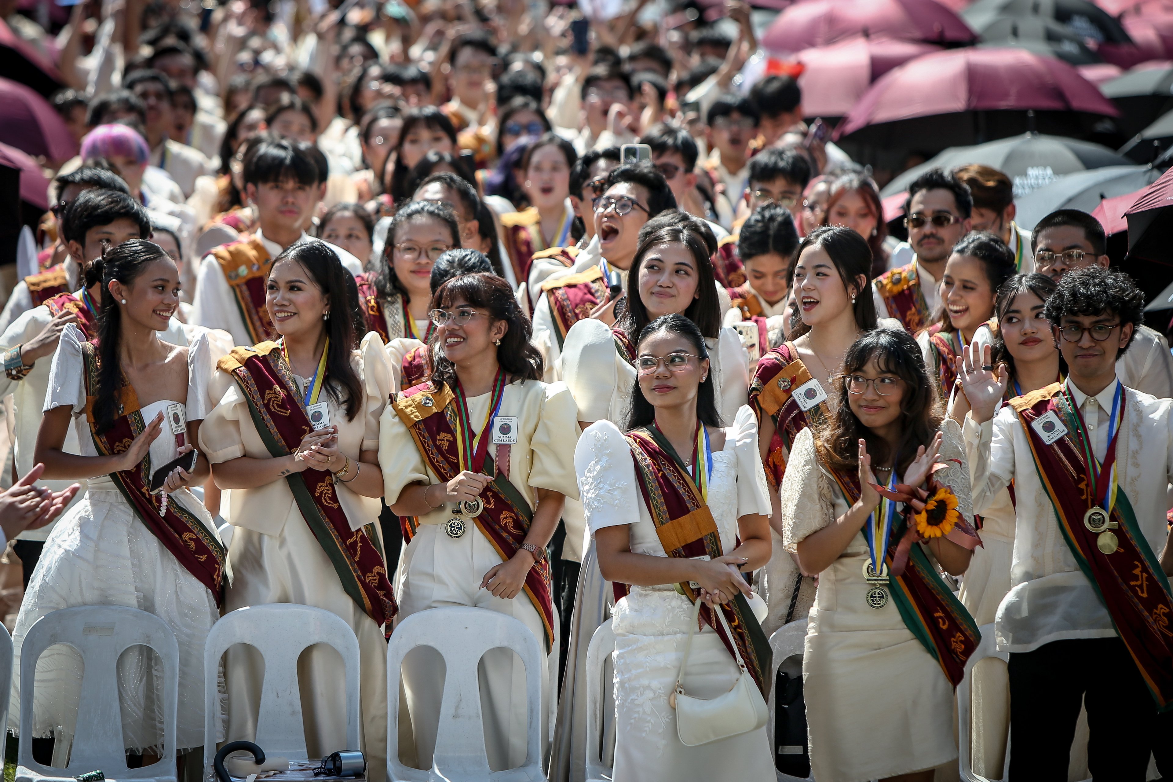 Various progressive graduates staged a protest after the graduation rites ceremony at University of the Philippines Diliman, Quezon City on Sunday, 5 July, 2026. 

Over 5022 students from various degrees celebrated their graduation rites.

Graduates were also seen to strike a pose at the University Avenue of UP Diliman on Sunday, 5 July, 2026 in Quezon City. | Aram Lascano
