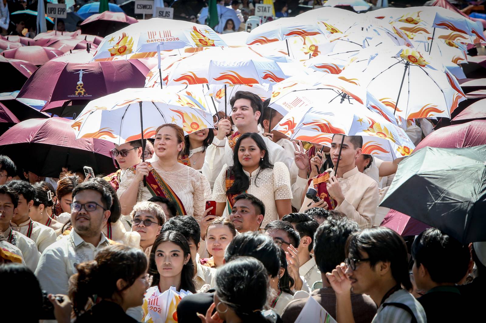 Various progressive graduates staged a protest after the graduation rites ceremony at University of the Philippines Diliman, Quezon City on Sunday, 5 July, 2026. 

Over 5022 students from various degrees celebrated their graduation rites.

Graduates were also seen to strike a pose at the University Avenue of UP Diliman on Sunday, 5 July, 2026 in Quezon City. | Aram Lascano