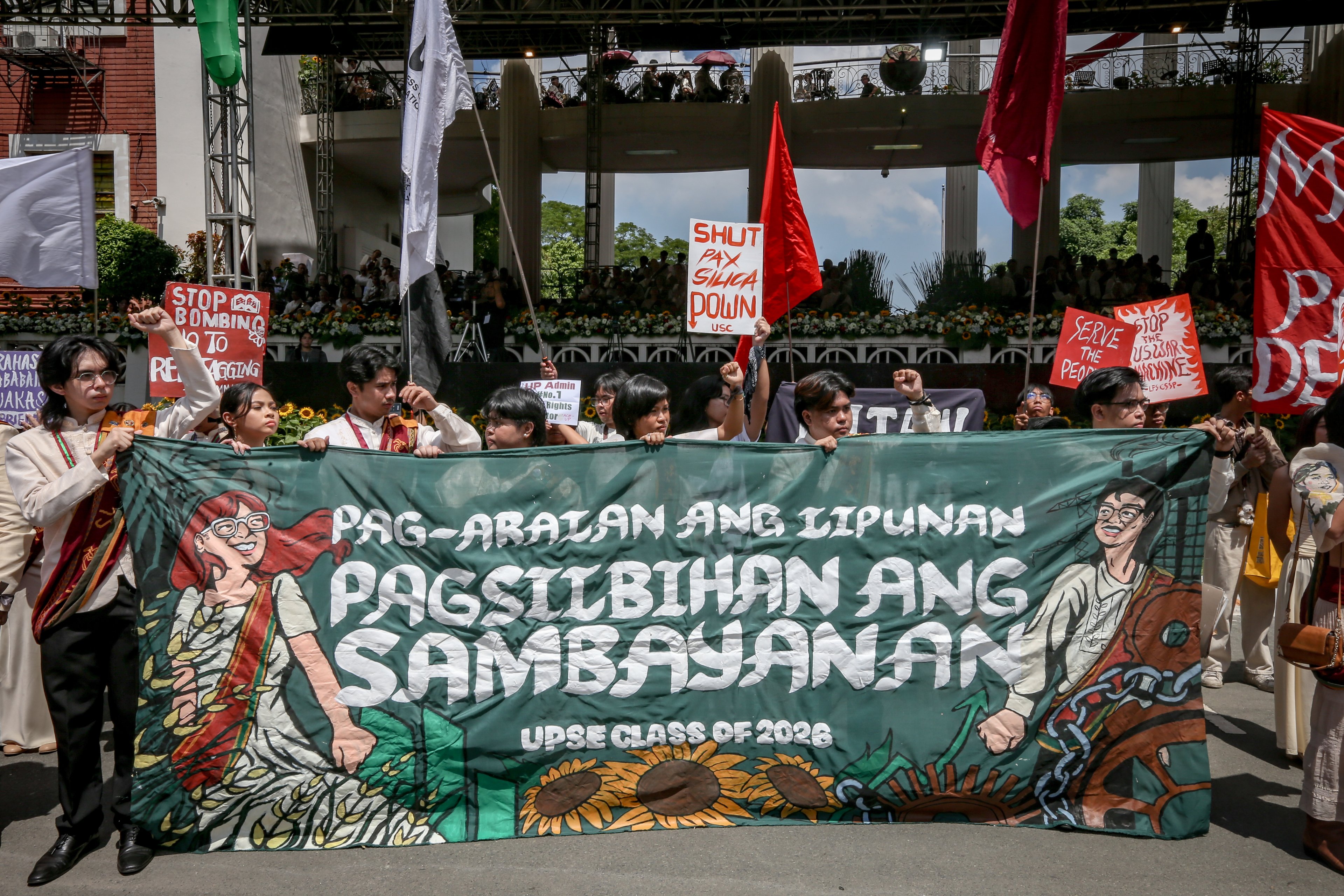 Various progressive graduates staged a protest after the graduation rites ceremony at University of the Philippines Diliman, Quezon City on Sunday, 5 July, 2026. 

Over 5022 students from various degrees celebrated their graduation rites.

Graduates were also seen to strike a pose at the University Avenue of UP Diliman on Sunday, 5 July, 2026 in Quezon City. | Aram Lascano