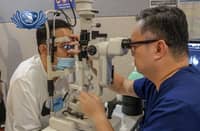 DR. Carlo Nasol (right) checks the eyes of Jhon Galapon, who is afflicted with diabetic retinopathy.