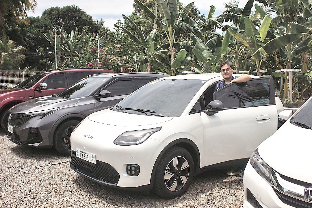 OWNER Paul Lacson uses his Rococo White GAC Aion UT for daily drives after choosing the EV hatchback for its comfort, range and lower running cost.