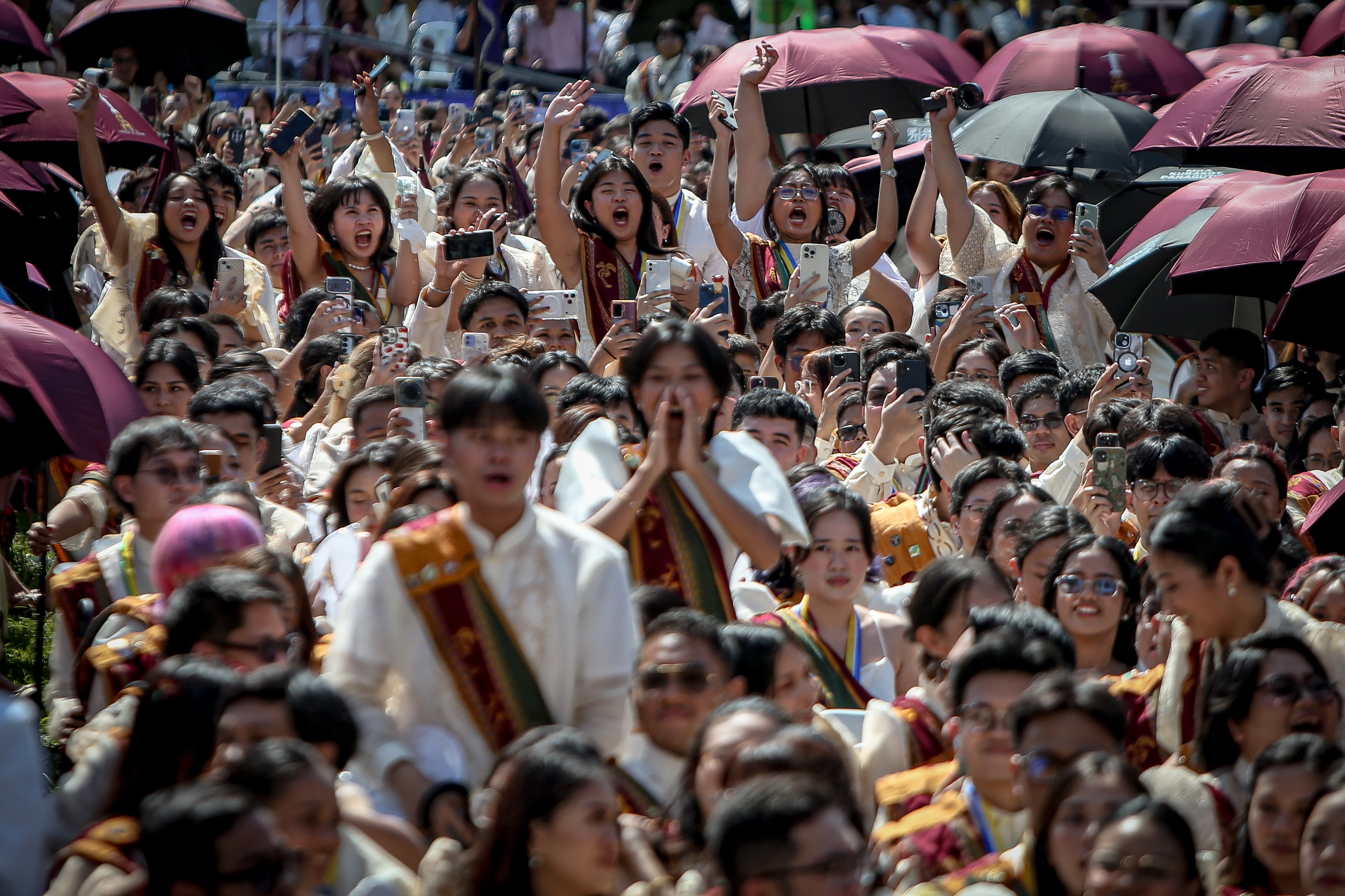 Various progressive graduates staged a protest after the graduation rites ceremony at University of the Philippines Diliman, Quezon City on Sunday, 5 July, 2026. 

Over 5022 students from various degrees celebrated their graduation rites.

Graduates were also seen to strike a pose at the University Avenue of UP Diliman on Sunday, 5 July, 2026 in Quezon City. | Aram Lascano