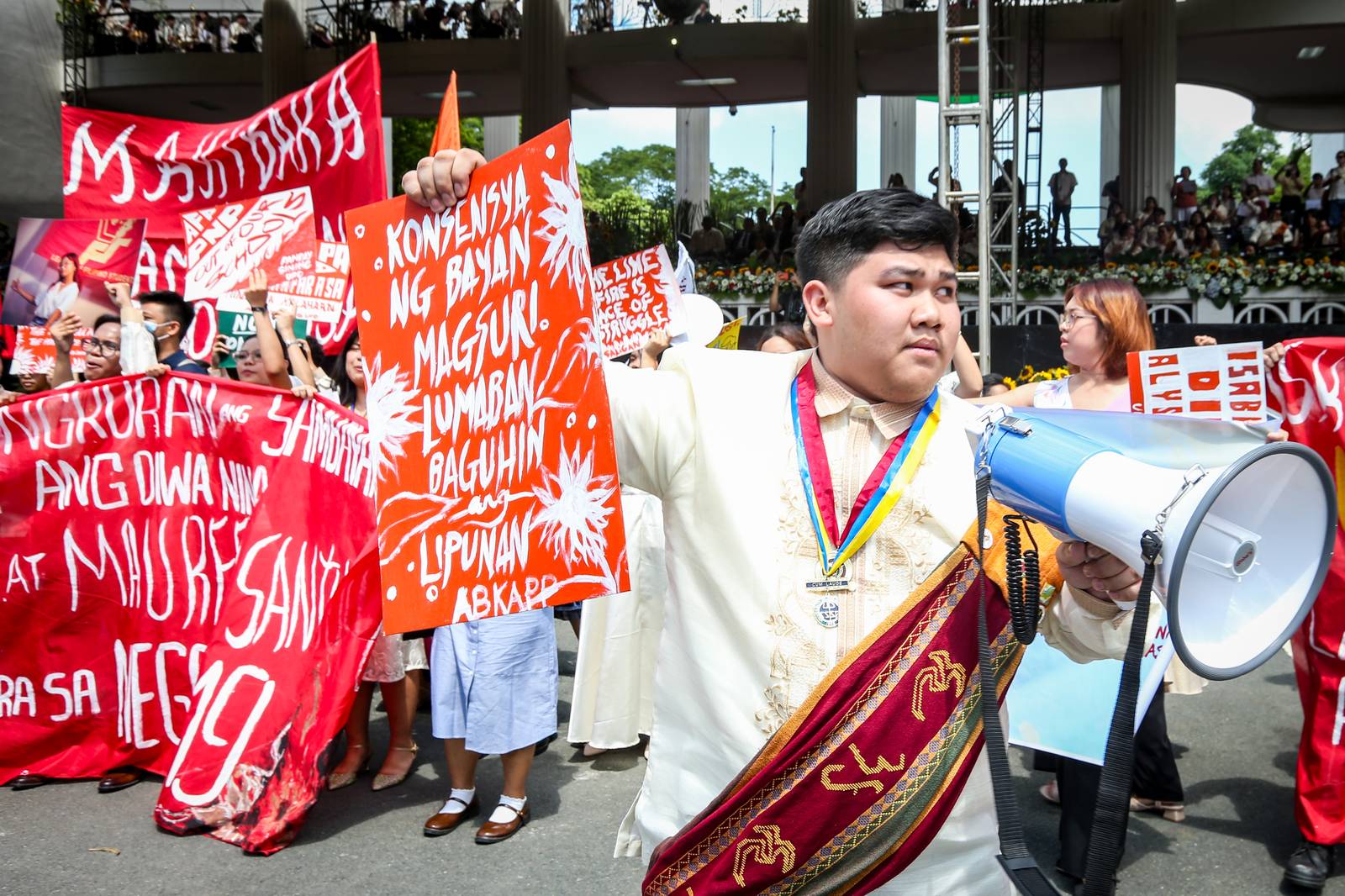 Various progressive graduates staged a protest after the graduation rites ceremony at University of the Philippines Diliman, Quezon City on Sunday, 5 July, 2026. 

Over 5022 students from various degrees celebrated their graduation rites.

Graduates were also seen to strike a pose at the University Avenue of UP Diliman on Sunday, 5 July, 2026 in Quezon City. | Aram Lascano