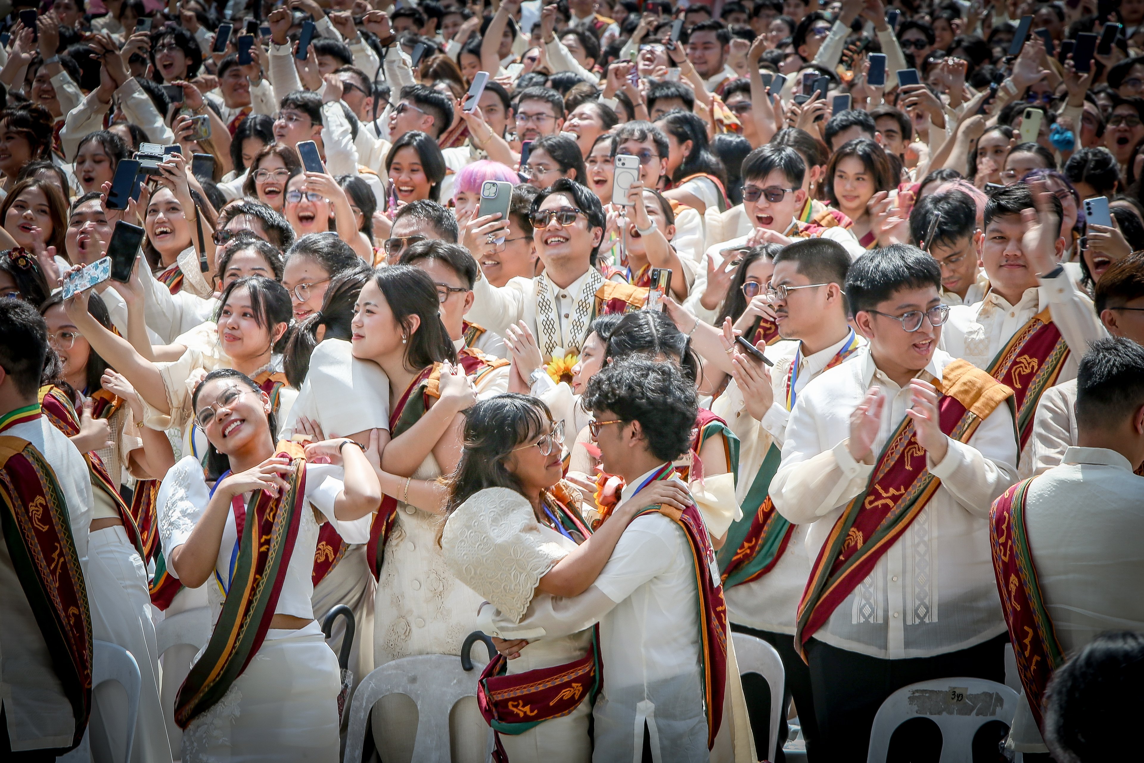 Various progressive graduates staged a protest after the graduation rites ceremony at University of the Philippines Diliman, Quezon City on Sunday, 5 July, 2026. 

Over 5022 students from various degrees celebrated their graduation rites.

Graduates were also seen to strike a pose at the University Avenue of UP Diliman on Sunday, 5 July, 2026 in Quezon City. | Aram Lascano