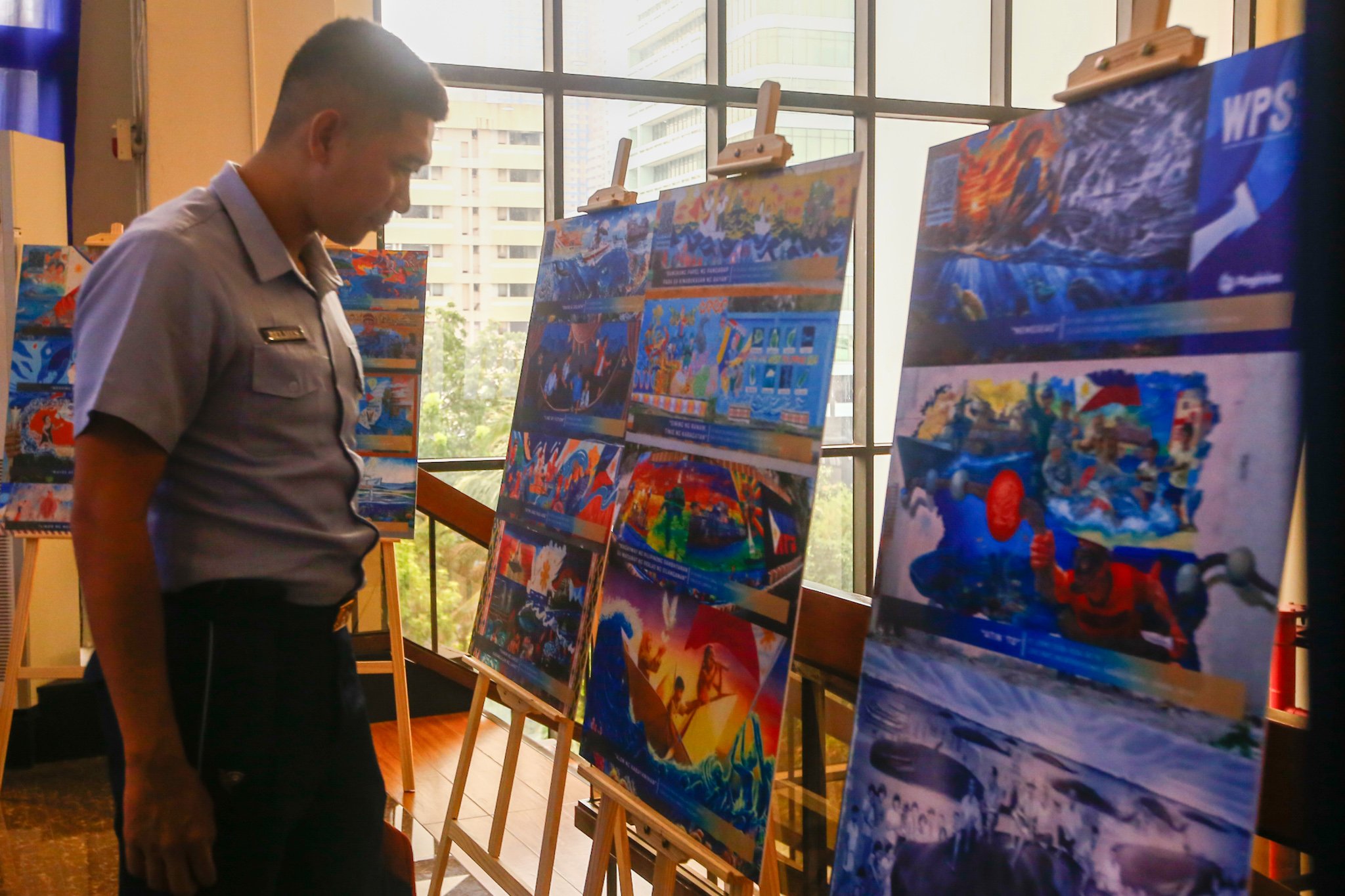 Visitors view reproductions of the mural entries for the WPS Mural Festival 2026 at the National Library in Manila on 07 July 2026, where the 100 finalists from across the country were unveiled. The festival coincides with the Philippines' commemoration of the 10th anniversary of the landmark 2016 arbitral award, which invalidated China's expansive claims in the South China Sea under the United Nations Convention on the Law of the Sea (UNCLOS).

Secretary of National Defense Gilbert Teodoro, retired Supreme Court Justice Antonio Carpio, Presidential Communications Office Undersecretary Claire Castro, Philippine Coast Guard Rear Admiral Jay T. Tarriela, Colonel Ma. Consuelo "Bon" Nunag-Castillo, documentary director Baby Ruth Villarama of Food Delivery, and other guests attend the unveiling of the finalists.