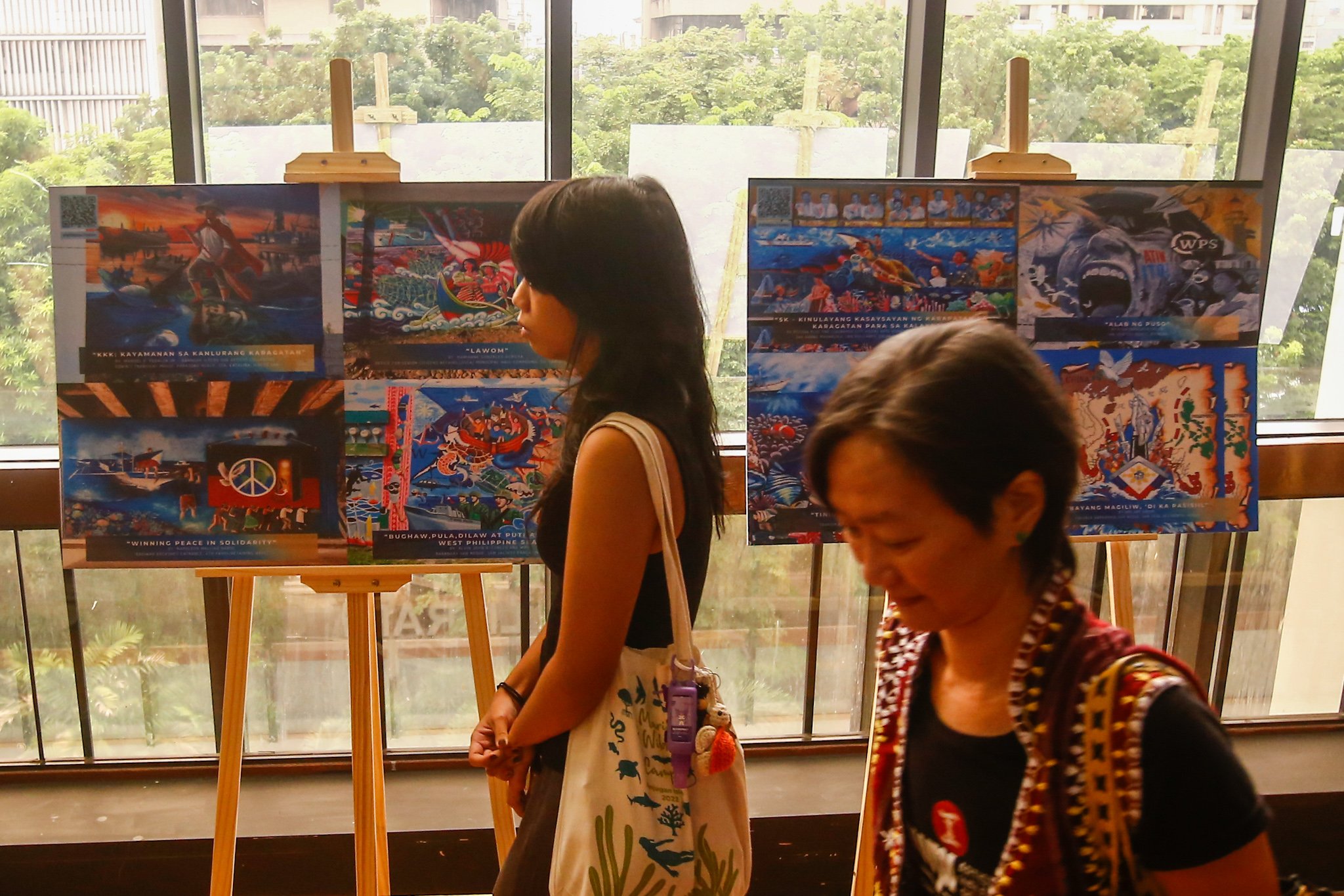 Visitors view reproductions of the mural entries for the WPS Mural Festival 2026 at the National Library in Manila on 07 July 2026, where the 100 finalists from across the country were unveiled. The festival coincides with the Philippines' commemoration of the 10th anniversary of the landmark 2016 arbitral award, which invalidated China's expansive claims in the South China Sea under the United Nations Convention on the Law of the Sea (UNCLOS).

Secretary of National Defense Gilbert Teodoro, retired Supreme Court Justice Antonio Carpio, Presidential Communications Office Undersecretary Claire Castro, Philippine Coast Guard Rear Admiral Jay T. Tarriela, Colonel Ma. Consuelo "Bon" Nunag-Castillo, documentary director Baby Ruth Villarama of Food Delivery, and other guests attend the unveiling of the finalists.