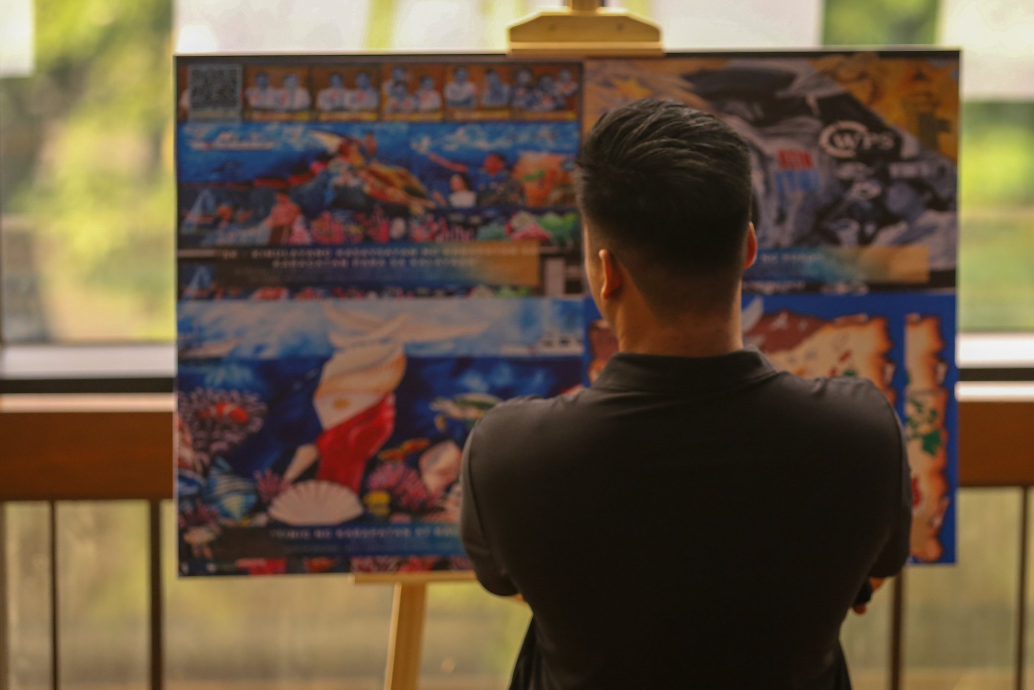 Visitors view reproductions of the mural entries for the WPS Mural Festival 2026 at the National Library in Manila on 07 July 2026, where the 100 finalists from across the country were unveiled. The festival coincides with the Philippines' commemoration of the 10th anniversary of the landmark 2016 arbitral award, which invalidated China's expansive claims in the South China Sea under the United Nations Convention on the Law of the Sea (UNCLOS).

Secretary of National Defense Gilbert Teodoro, retired Supreme Court Justice Antonio Carpio, Presidential Communications Office Undersecretary Claire Castro, Philippine Coast Guard Rear Admiral Jay T. Tarriela, Colonel Ma. Consuelo "Bon" Nunag-Castillo, documentary director Baby Ruth Villarama of Food Delivery, and other guests attend the unveiling of the finalists.