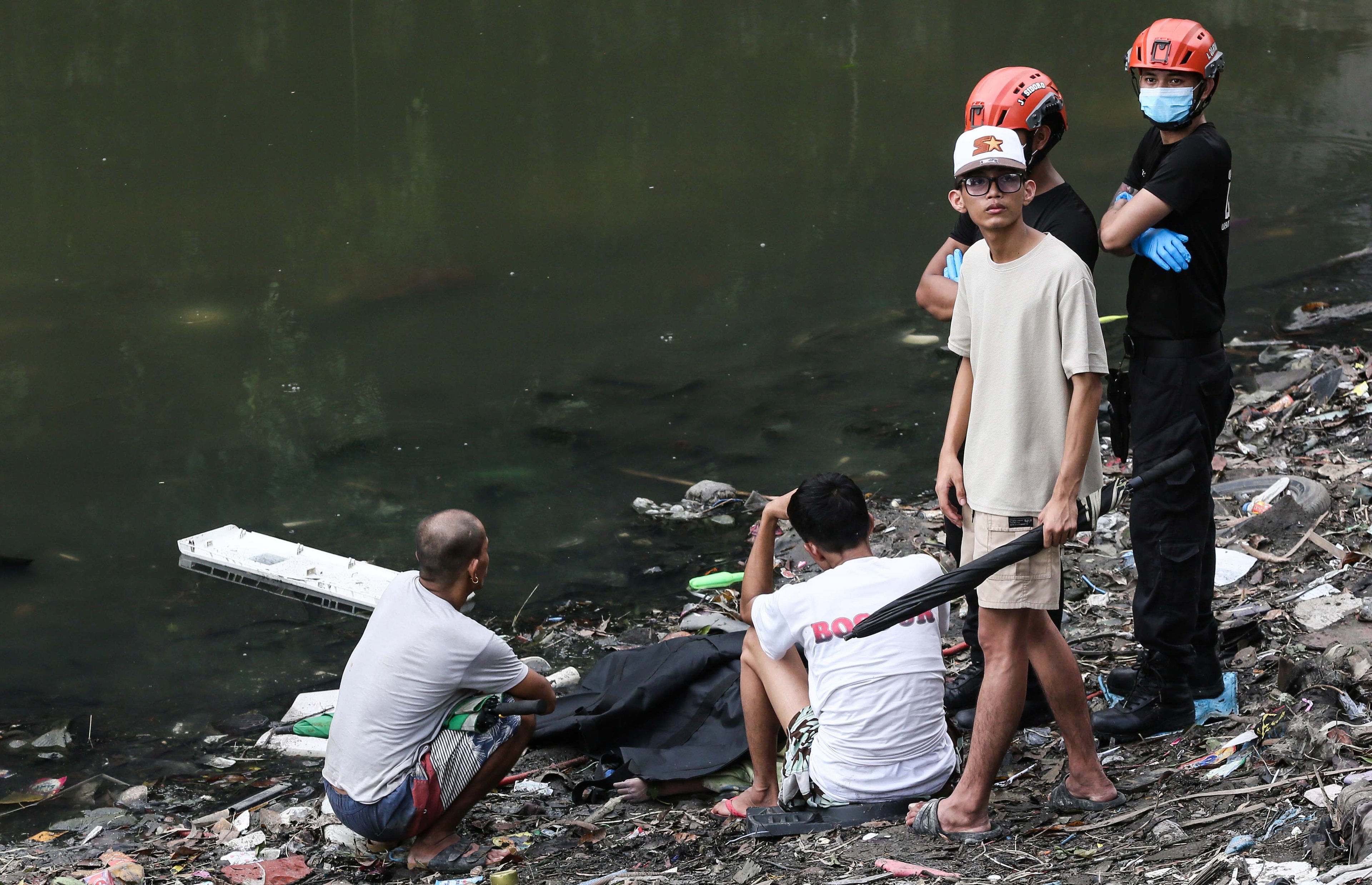 (July 07 2026) Scene of the Crime Operative SOCO investigate the lifeless body of the seven year old boy allegedly fell off at Dario river while flying a kite at Brgy. Bahay Toro in Quezon City on Monday afternoon, due to heavy rain and the water flow going strong the body was found at San Juan river in Brgy Apolonio Samson, Quezon City. Photo/Analy Labor