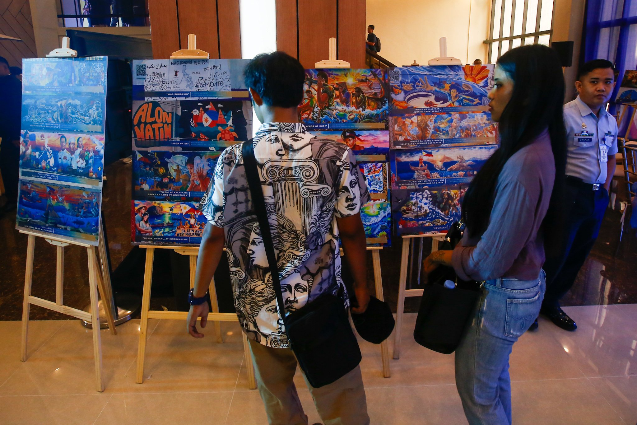 Visitors view reproductions of the mural entries for the WPS Mural Festival 2026 at the National Library in Manila on 07 July 2026, where the 100 finalists from across the country were unveiled. The festival coincides with the Philippines' commemoration of the 10th anniversary of the landmark 2016 arbitral award, which invalidated China's expansive claims in the South China Sea under the United Nations Convention on the Law of the Sea (UNCLOS).

Secretary of National Defense Gilbert Teodoro, retired Supreme Court Justice Antonio Carpio, Presidential Communications Office Undersecretary Claire Castro, Philippine Coast Guard Rear Admiral Jay T. Tarriela, Colonel Ma. Consuelo "Bon" Nunag-Castillo, documentary director Baby Ruth Villarama of Food Delivery, and other guests attend the unveiling of the finalists.