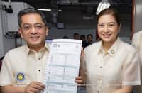 Comelec Chairman George Erwin Garcia shows off a printed sample ballot for the BARMM elections on 14 September 2026.