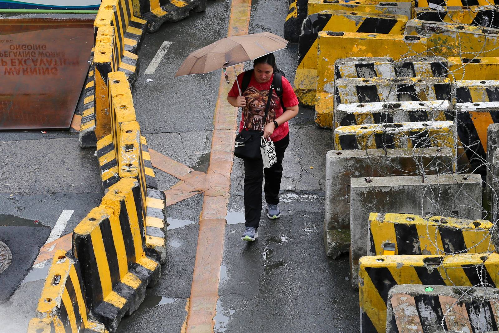 Concrete barriers, razor wire, and container vans block roads leading to the Malacañang Complex in Manila on 10 July 2026 as authorities tighten security ahead of an anti-corruption protest at Liwasang Bonifacio organized by an interfaith group.