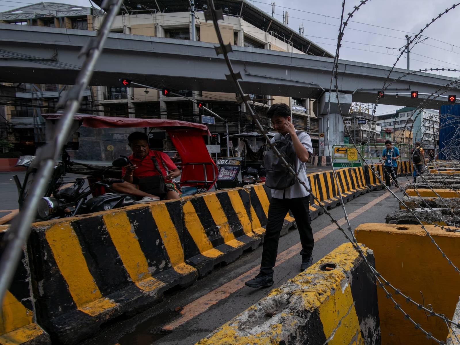 Concrete barriers, razor wire, and container vans block roads leading to the Malacañang Complex in Manila on 10 July 2026 as authorities tighten security ahead of an anti-corruption protest at Liwasang Bonifacio organized by an interfaith group.
