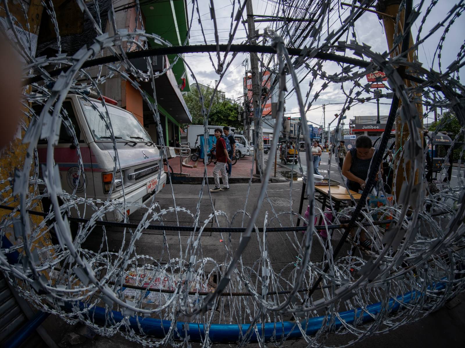 Concrete barriers, razor wire, and container vans block roads leading to the Malacañang Complex in Manila on 10 July 2026 as authorities tighten security ahead of an anti-corruption protest at Liwasang Bonifacio organized by an interfaith group.
