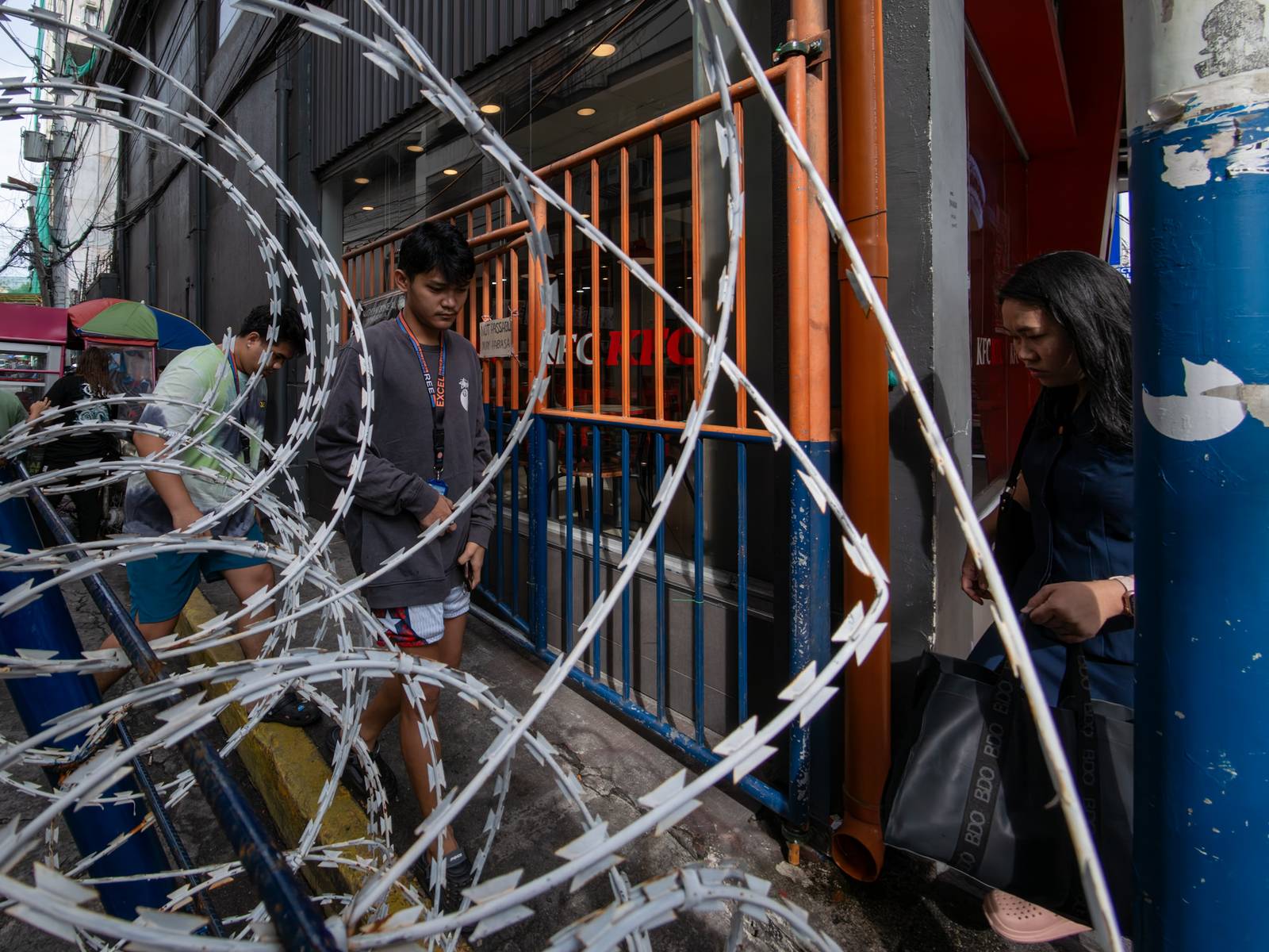 Concrete barriers, razor wire, and container vans block roads leading to the Malacañang Complex in Manila on 10 July 2026 as authorities tighten security ahead of an anti-corruption protest at Liwasang Bonifacio organized by an interfaith group.