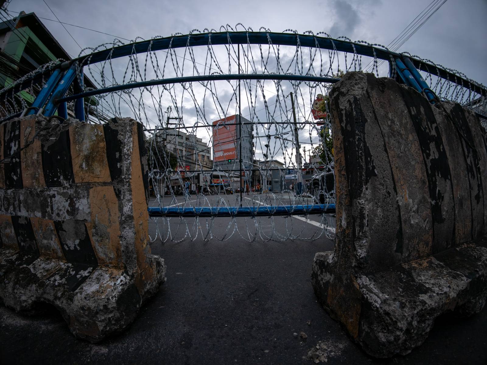 Concrete barriers, razor wire, and container vans block roads leading to the Malacañang Complex in Manila on 10 July 2026 as authorities tighten security ahead of an anti-corruption protest at Liwasang Bonifacio organized by an interfaith group.