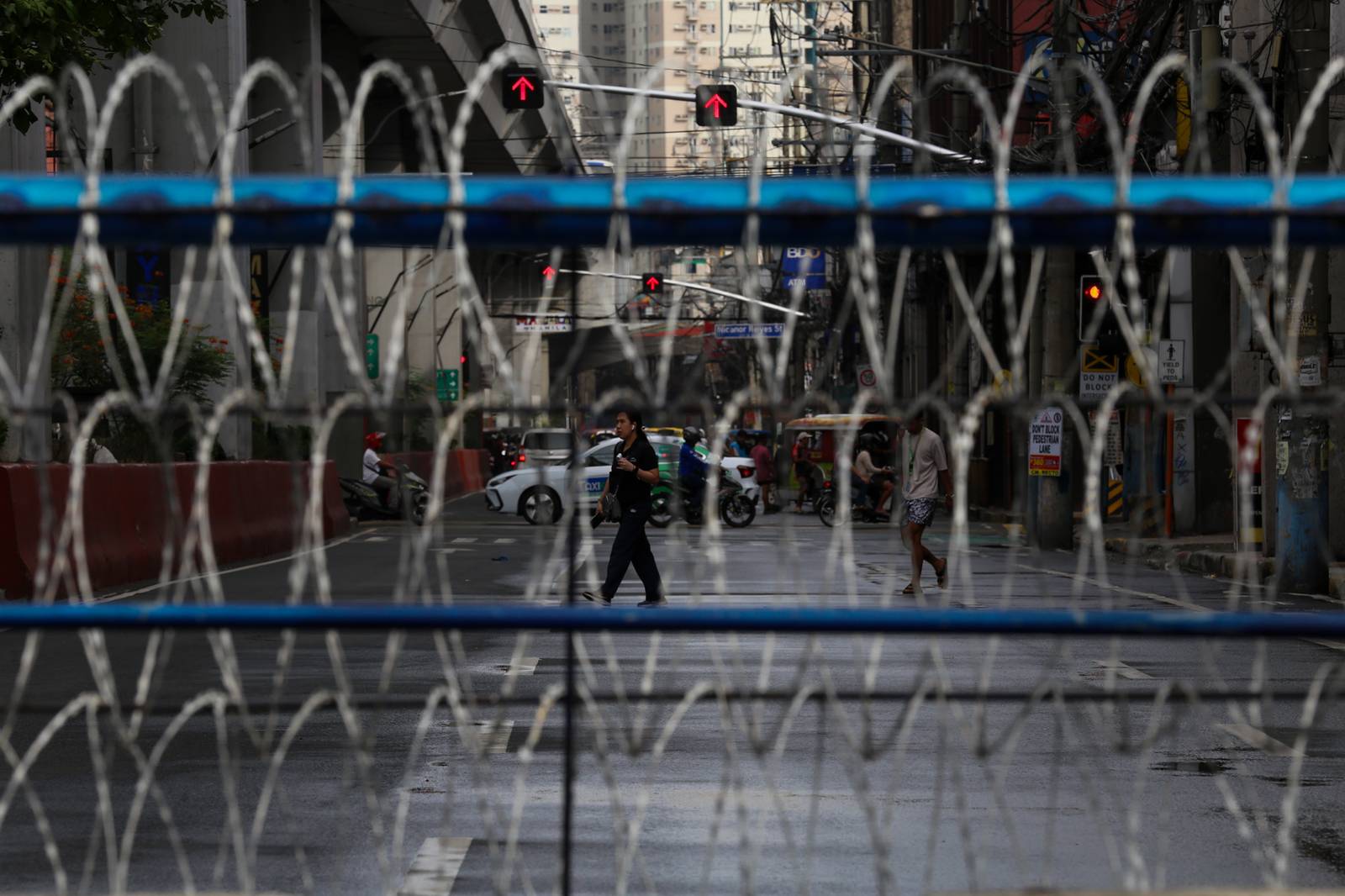 Concrete barriers, razor wire, and container vans block roads leading to the Malacañang Complex in Manila on 10 July 2026 as authorities tighten security ahead of an anti-corruption protest at Liwasang Bonifacio organized by an interfaith group.